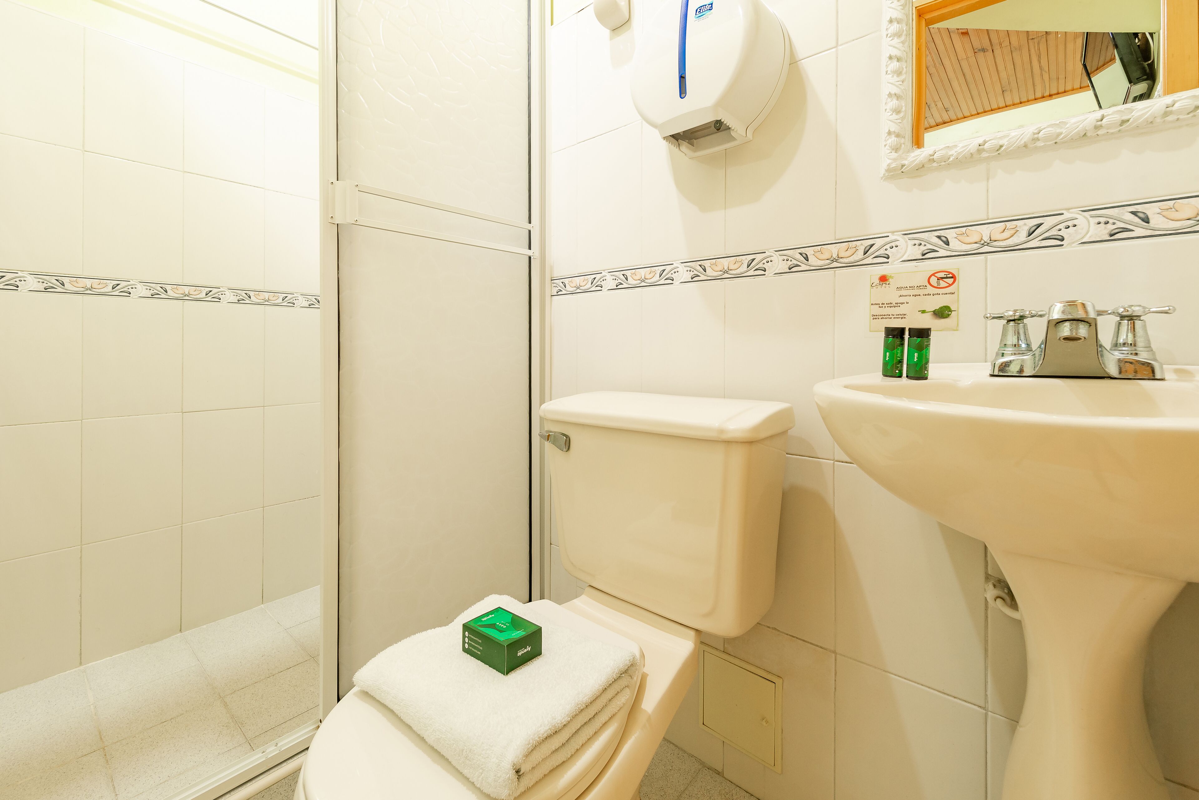 A bathroom with a toilet, a sink, and a shower.