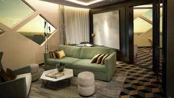 A modern living room with a green sofa, a coffee table, and a view of the countryside through a large window.
