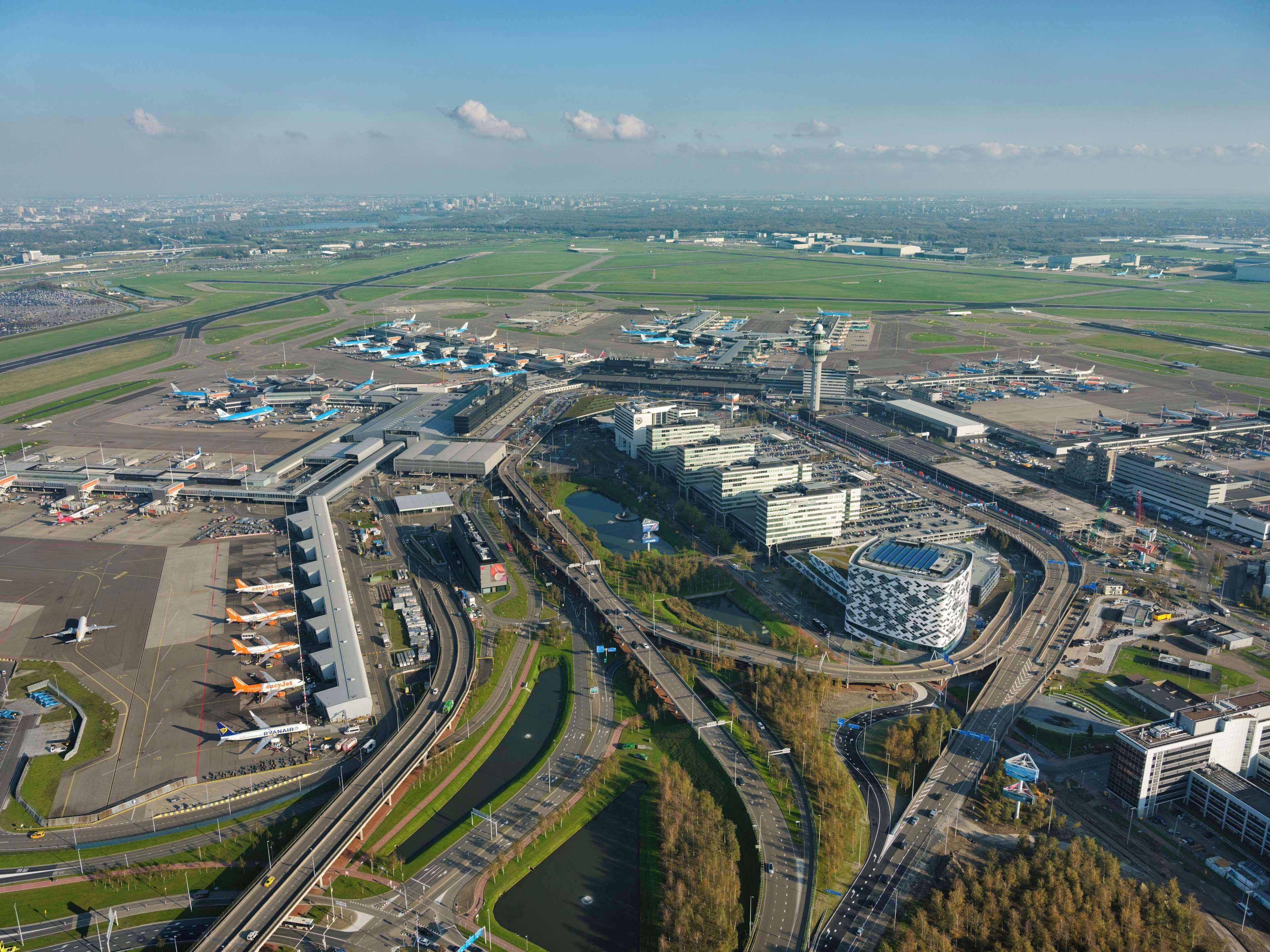 An airport with multiple terminals, runways, and a control tower.
