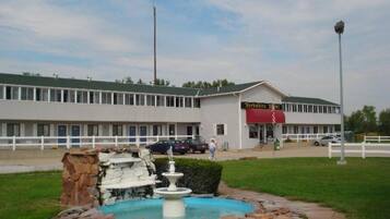 A building with a sign reading "Yorkshire Inn" and a fountain in the foreground.