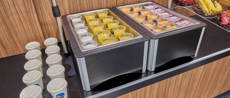 A buffet with various food items and beverages.