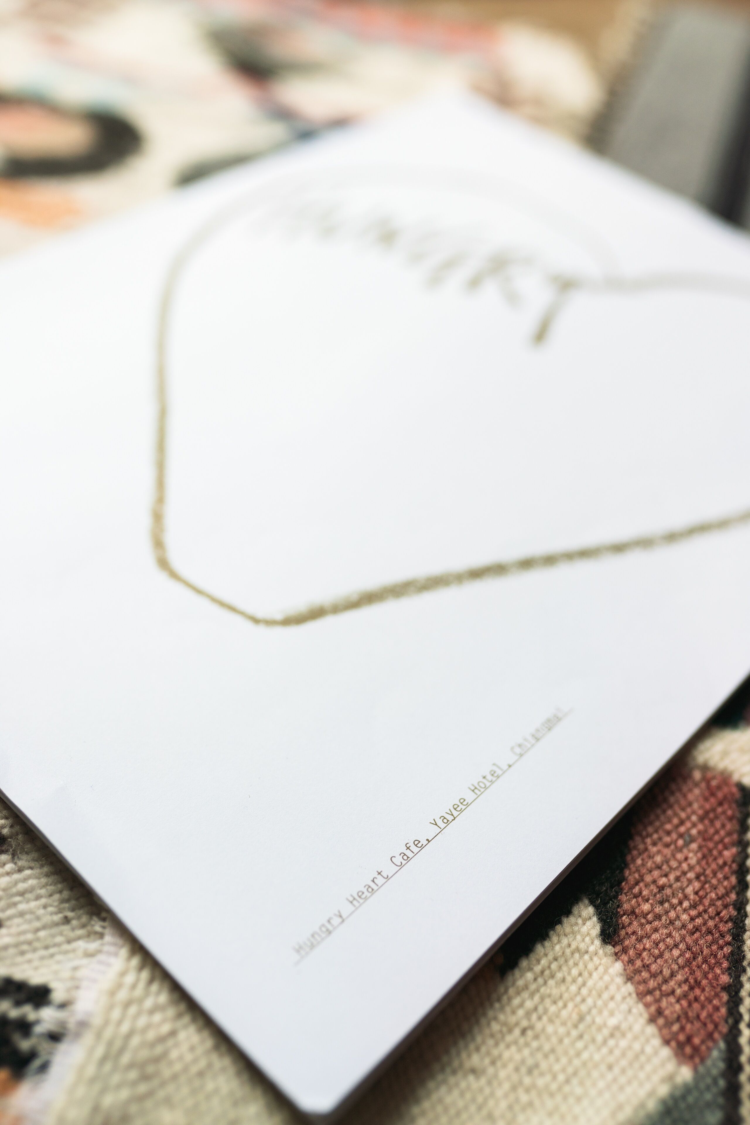 A white menu card with the text "Hungry Heart Cafe, Yabee Hotel, Lake Tahoe."