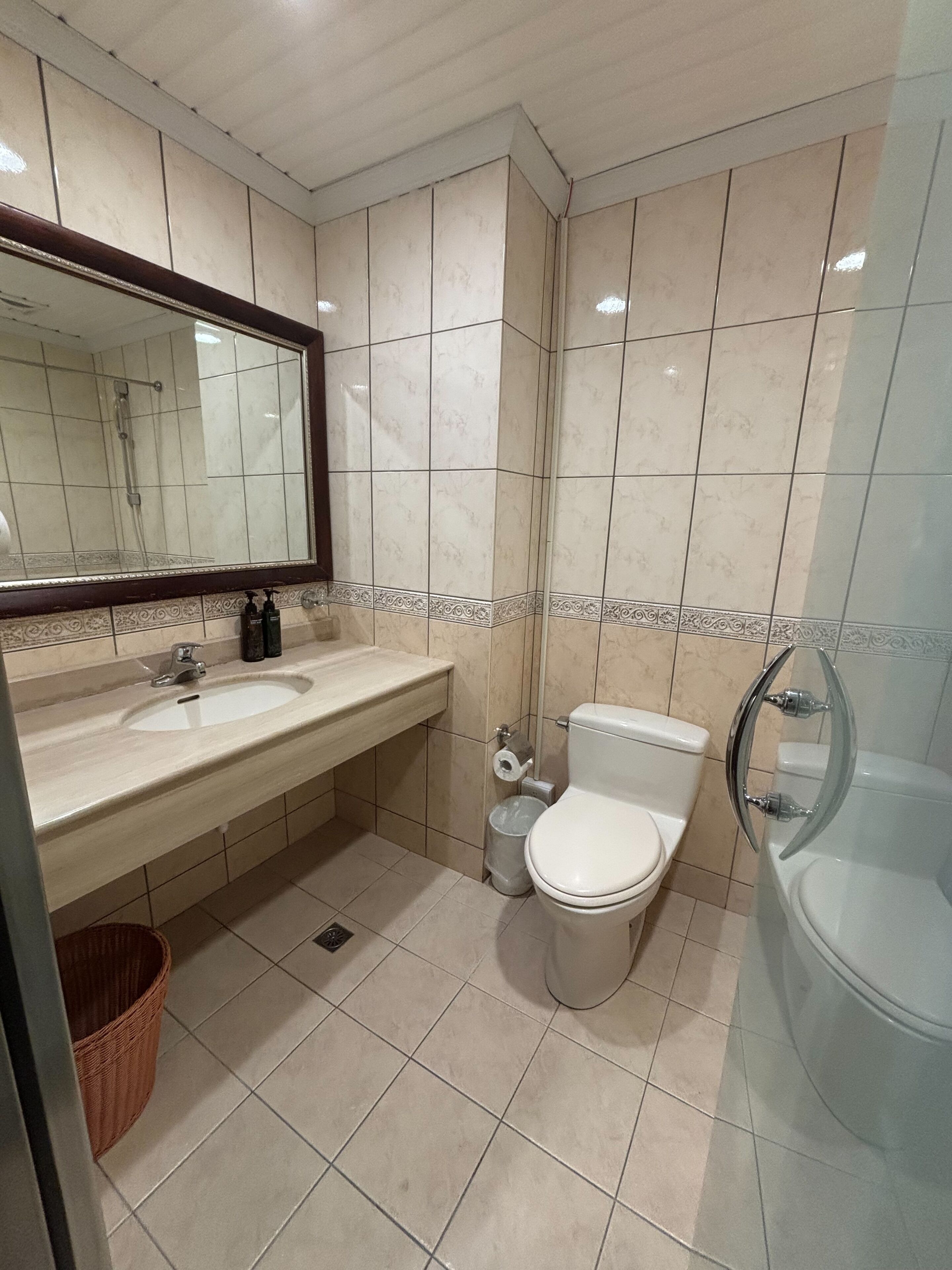 A bathroom with a sink, toilet, and bathtub.