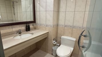 A bathroom with a sink, toilet, and bathtub.