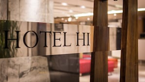 A hotel sign with the name "HOTEL HI" in a modern interior setting. - Hotel Hi Chuiyang (Chiayi City)
