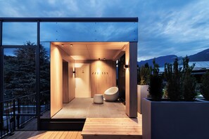 Un intérieur moderne avec un plancher en bois, un coin salon et une vue sur l’extérieur.
