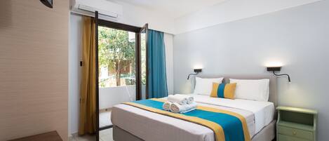 A modern hotel room with a large bed, a bedside table, a nightstand, and a window with curtains.