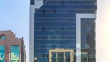 A modern building with "EXECUTIVE SUITES" signage, featuring a glass facade and a prominent entrance.