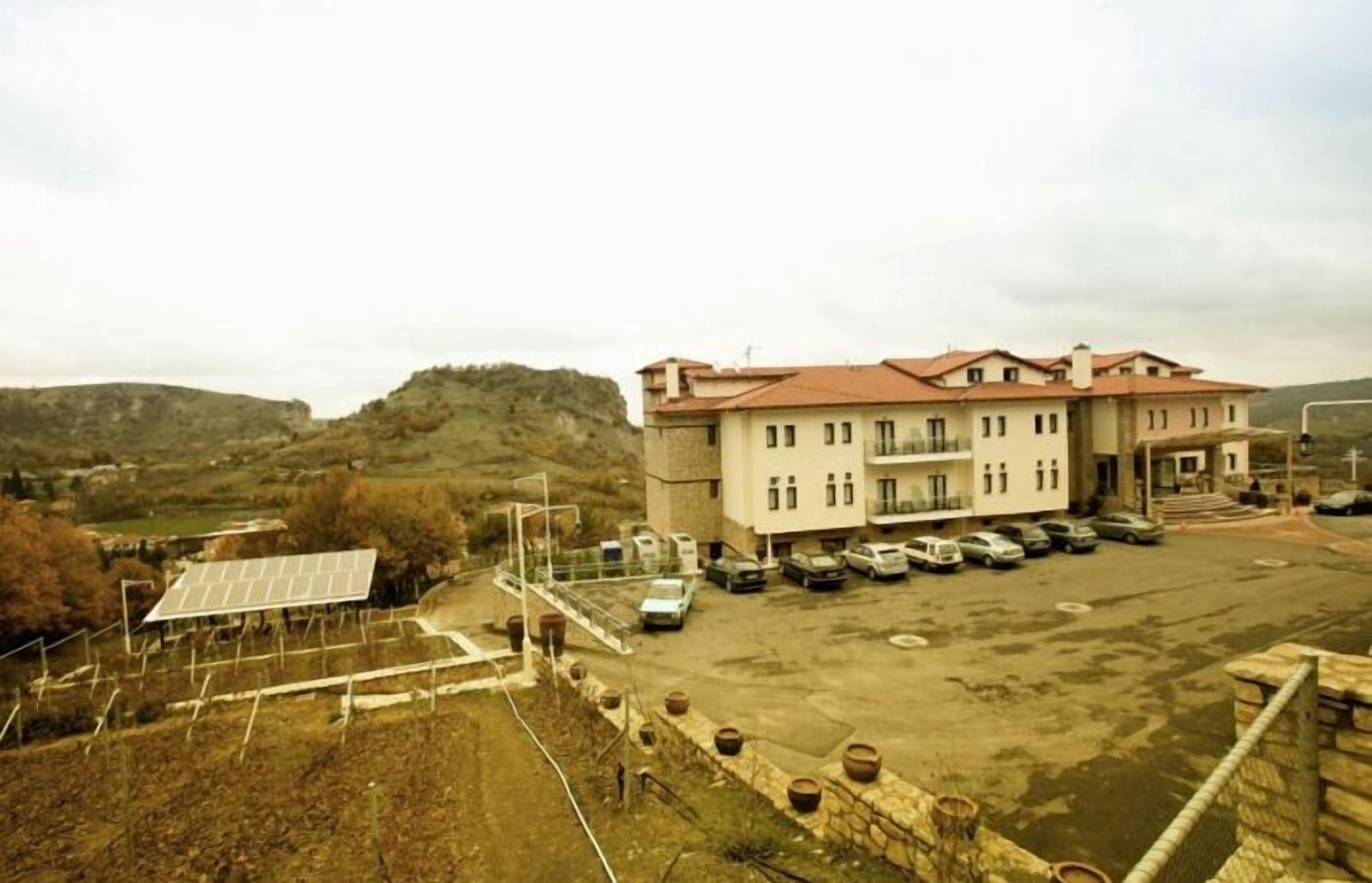 A building with a parking lot and solar panels.