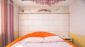 Un dormitorio con cama, mesita de noche y cabecero.