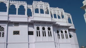 A white building with multiple windows and decorative arches. - Bhanwar Vilas Guest House (Udaipur)