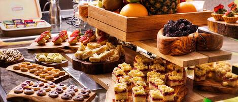 A buffet with various desserts and fruits.