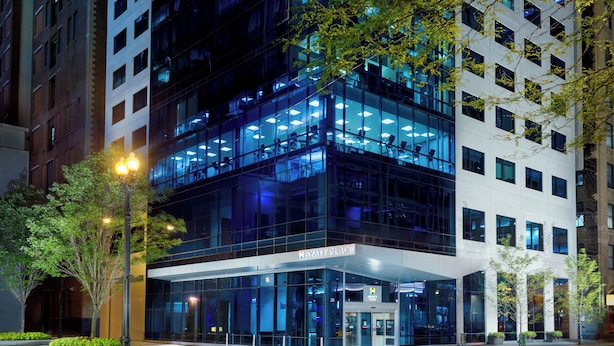 A modern hotel with a glass facade, multiple floors, and a visible entrance. - Hyatt Place Chicago/Downtown - The Loop (Chicago)