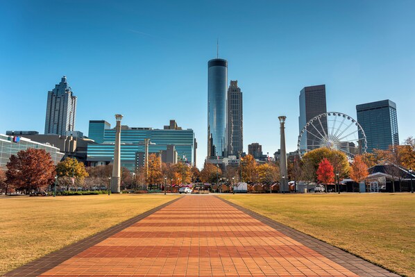 A cityscape with a prominent skyscraper, a Ferris wheel, and a clear sky. - Hotel Indigo Atlanta Downtown by IHG (Atlanta)