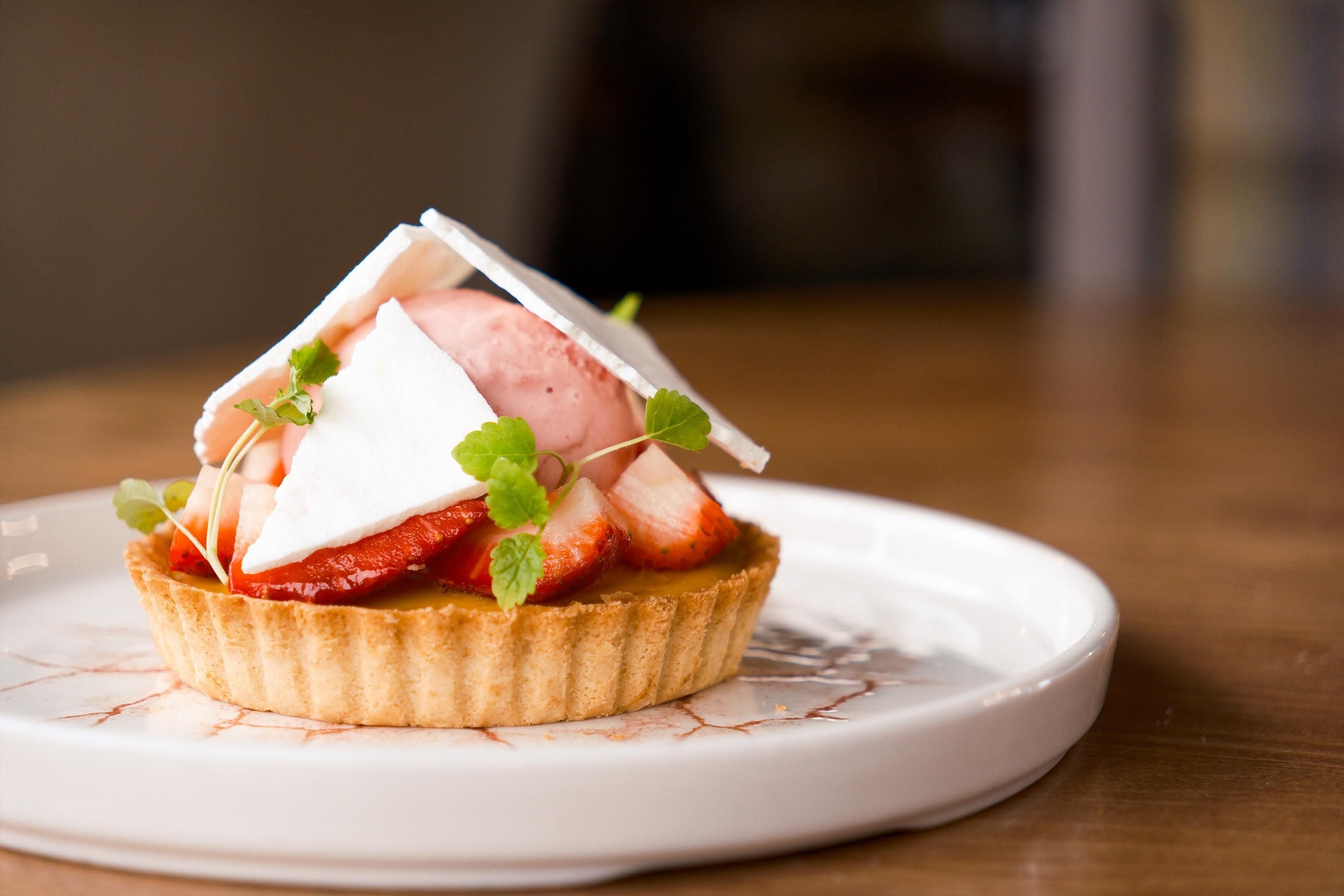 A dessert on a white plate with a textured rim.