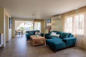 Luxury 3 bedroom Apartment, Ocean View - Turquoise Wave | Living room | 65-inch Smart TV with cable channels, DVD player, toys - Curacao Luxury Holiday Rentals (Willemstad)