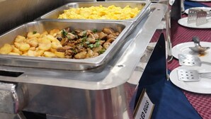 A buffet with various food options including scrambled eggs, roasted potatoes, and a dish labeled "Boiled Eggs". - Rainbow Hotel (Dar es Salaam)