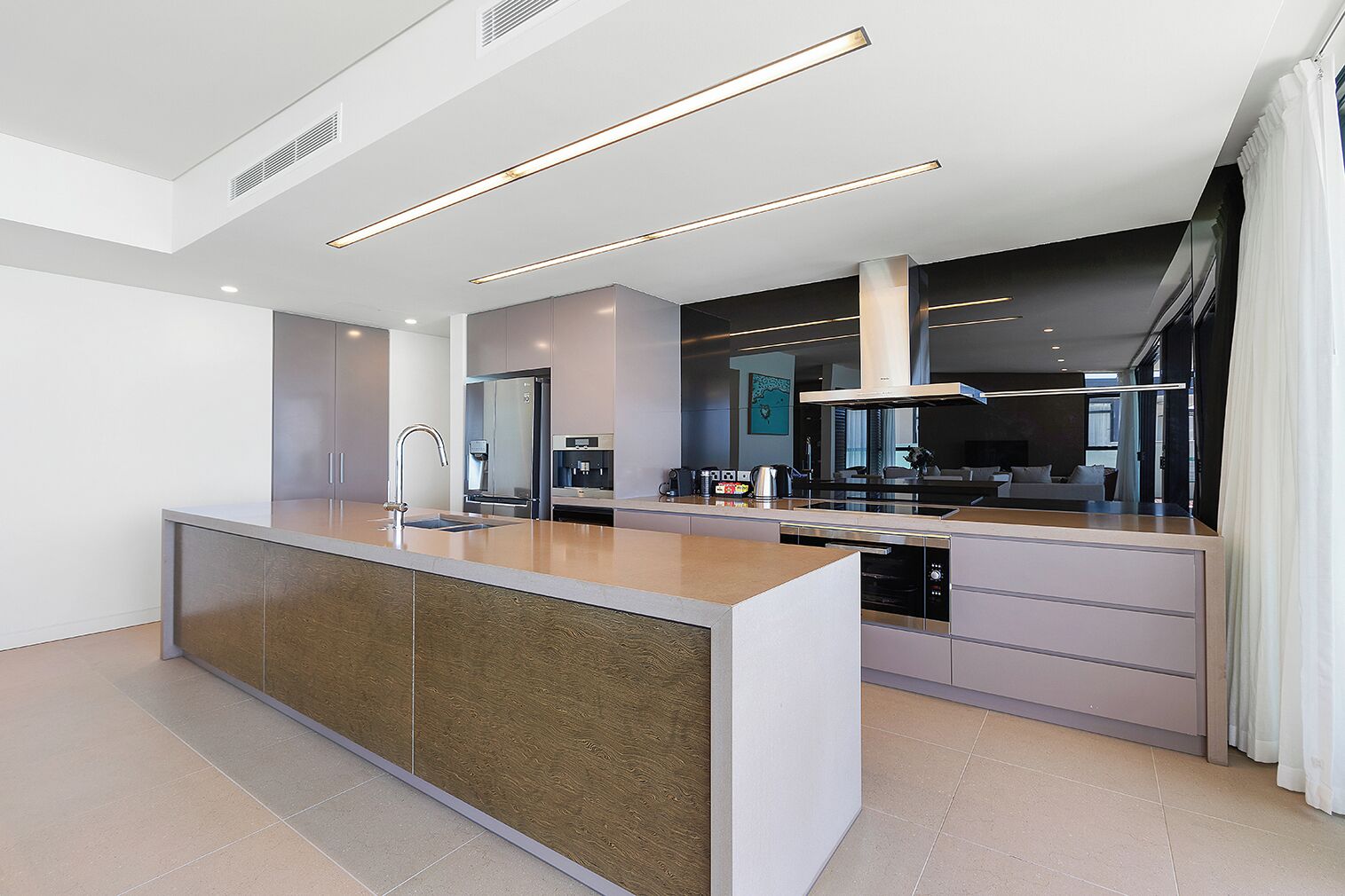 A modern kitchen with a central island, built-in appliances, and a sleek design.
