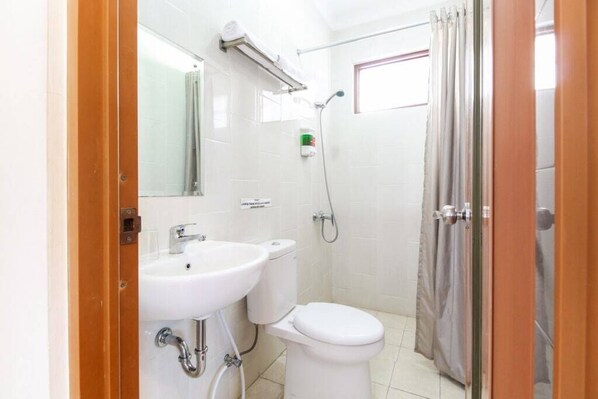 A bathroom with a toilet, sink, and shower. - My Residence Cirebon (West Cirebon)