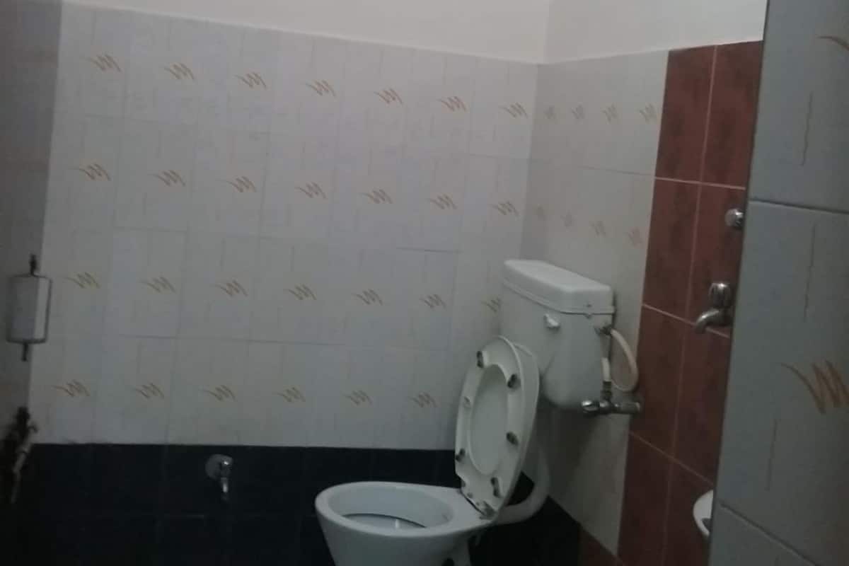 A bathroom with a toilet, a sink, and a shower.
