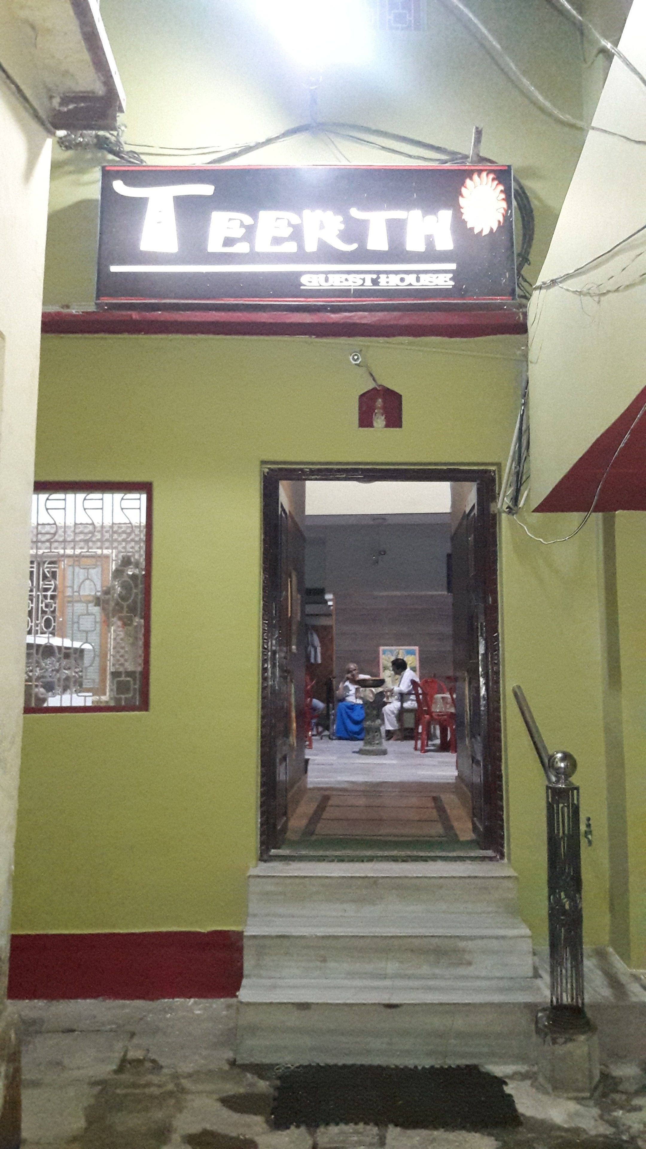 A building entrance with a sign reading "TEETH GUEST HOUSE".