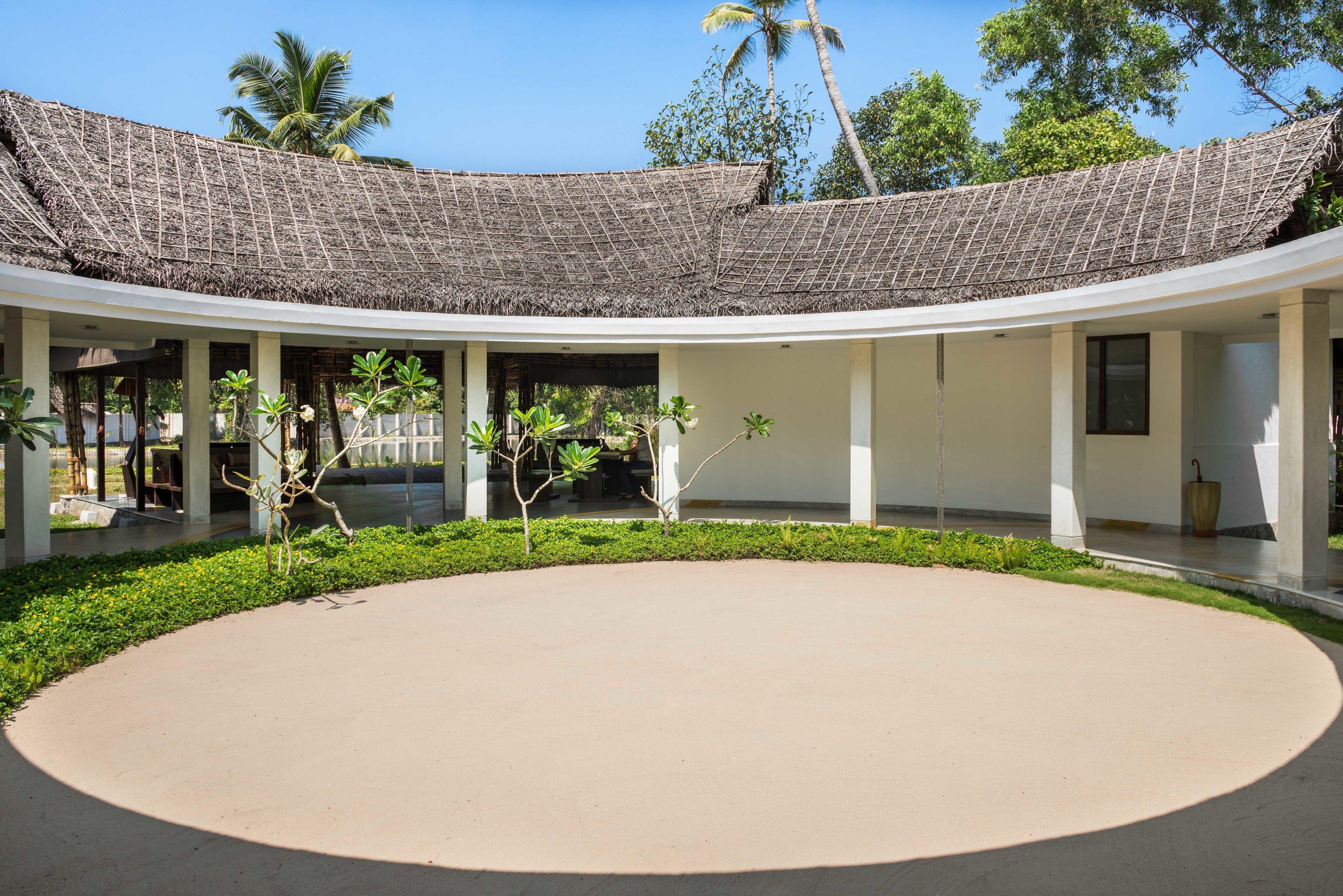 A building with a curved roof and a central open courtyard.