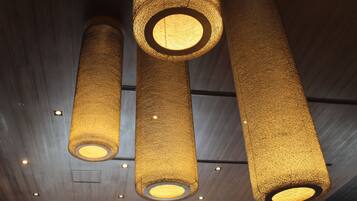 Three cylindrical light fixtures with a textured surface and circular openings.