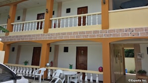 A two-story building with a balcony, white railings, and a tiled facade. - Gemini Hotel & Restaurant (Panglao)