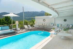 Una piscina al aire libre, una piscina en la azotea, sombrillas