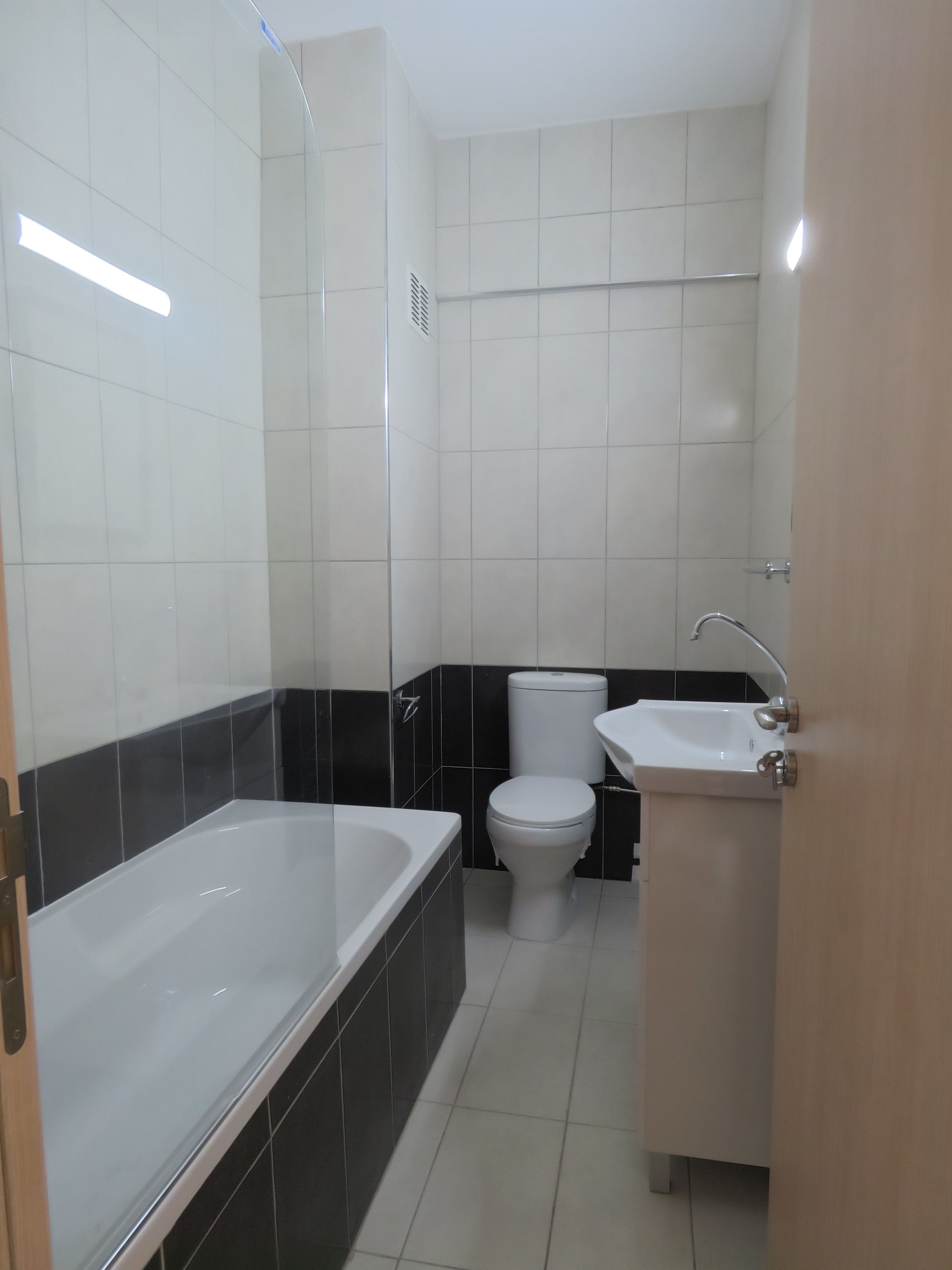 A bathroom with a bathtub, toilet, and sink.