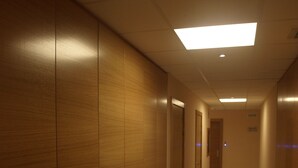 A corridor with wooden paneling and doors, leading to a room with a visible door at the end. - Hostal Aralar (Berrioplano)