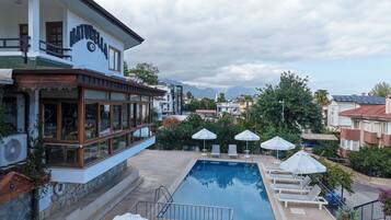 Outdoor pool, a waterfall pool, pool loungers