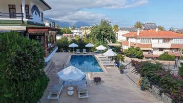 Outdoor pool, a waterfall pool, pool loungers