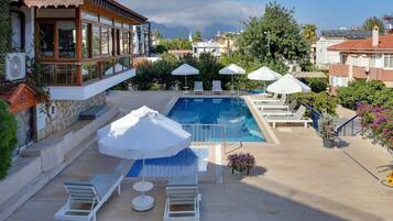 Outdoor pool, a waterfall pool, pool loungers
