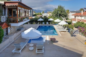 Outdoor pool, a waterfall pool, pool loungers