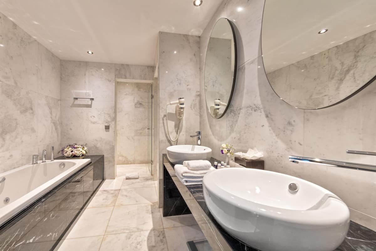 junior suite, 1 king bed, river view | bathroom | designer toiletries, hair dryer, bathrobes, slippers