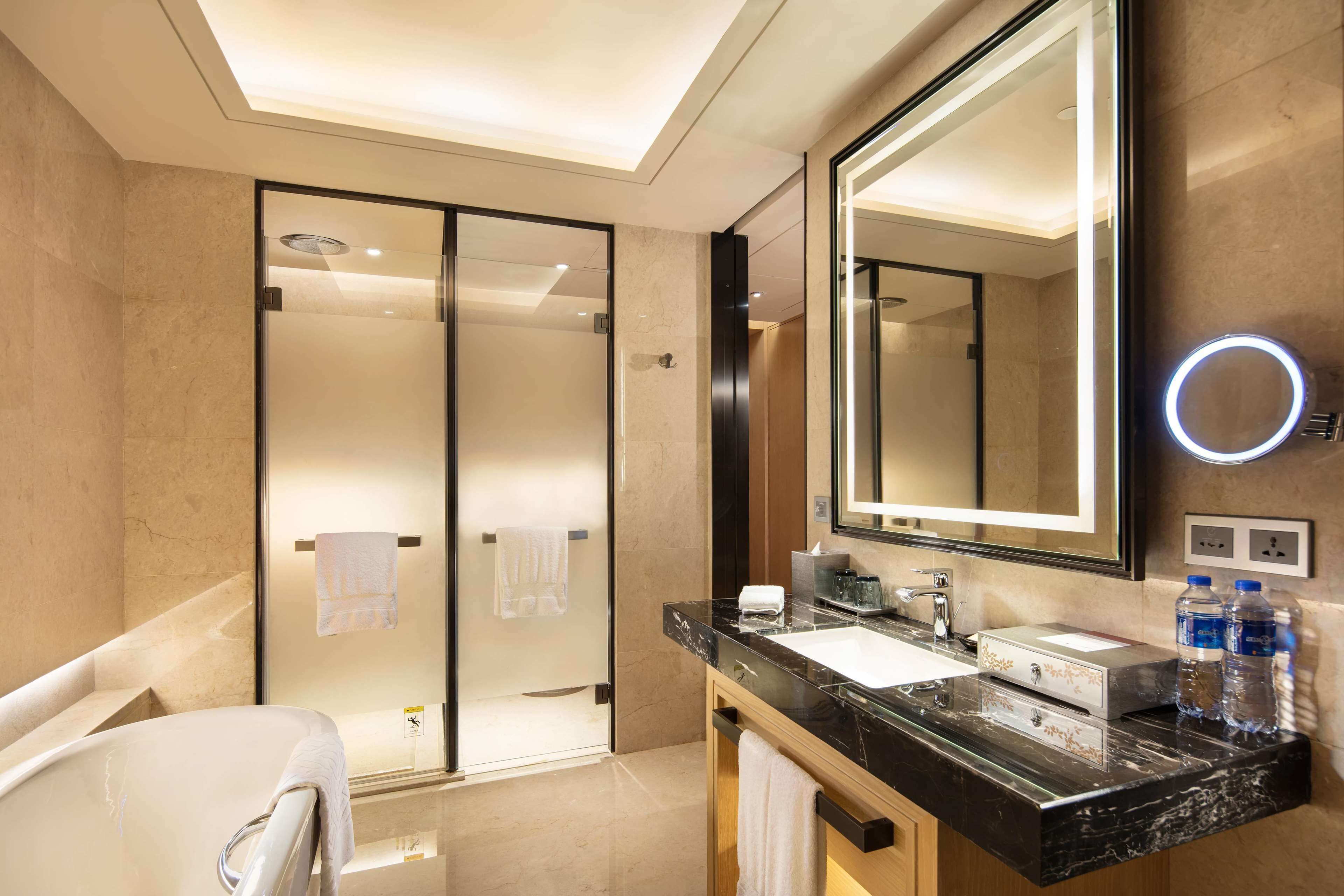 king, deluxe suite | bathroom | separate bathtub and shower, rainfall showerhead, free toiletries