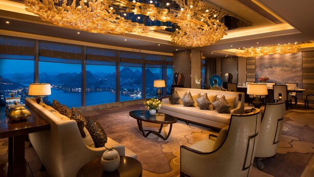 A luxurious lobby with a large chandelier, a sofa set, and a view of a cityscape through large windows. - DoubleTree by Hilton Hotel Anshun (Anshun)