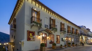 A two-story building with a sign for 'Kastalia' on the facade, multiple balconies with plants, and a street view. - Kastalia Boutique Hotel (Delphi)