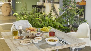 A breakfast table with various food items and a bottle of oil. - Kastalia Boutique Hotel (Delphi)