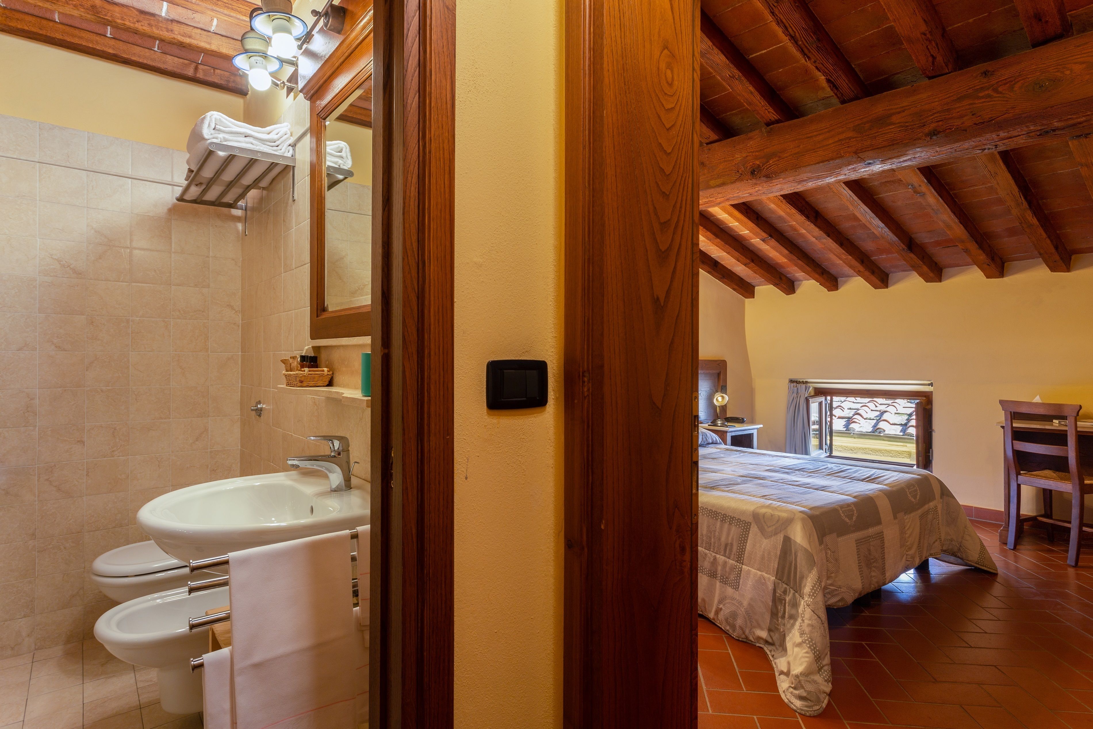 A bathroom with a sink, toilet, and towel rack.