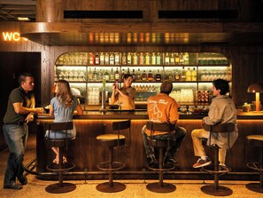 A bar area with stools and a bartender. - Red Roof Inn PLUS+ Williams - Grand Canyon (Williams)