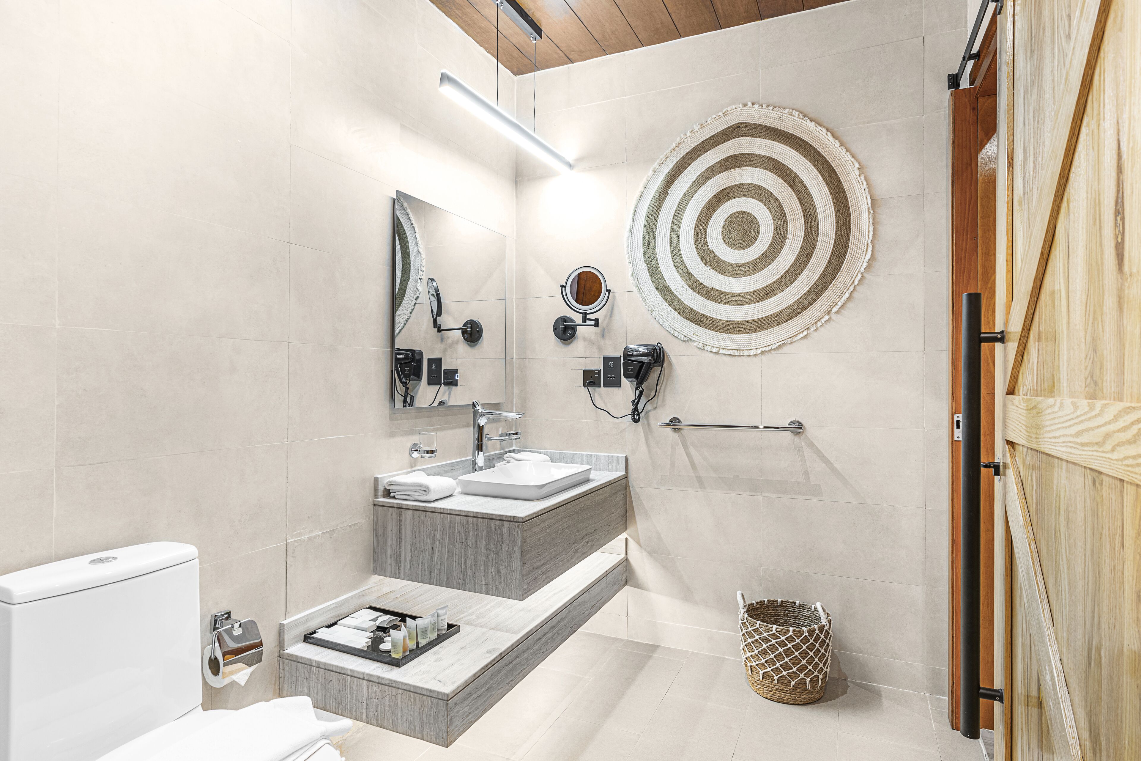 A modern bathroom with a vanity, sink, and mirror.