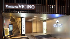 The exterior of Trattoria Vicino with a staircase leading to the entrance. - Hotel MyStays Gotanda Station (Tokyo)