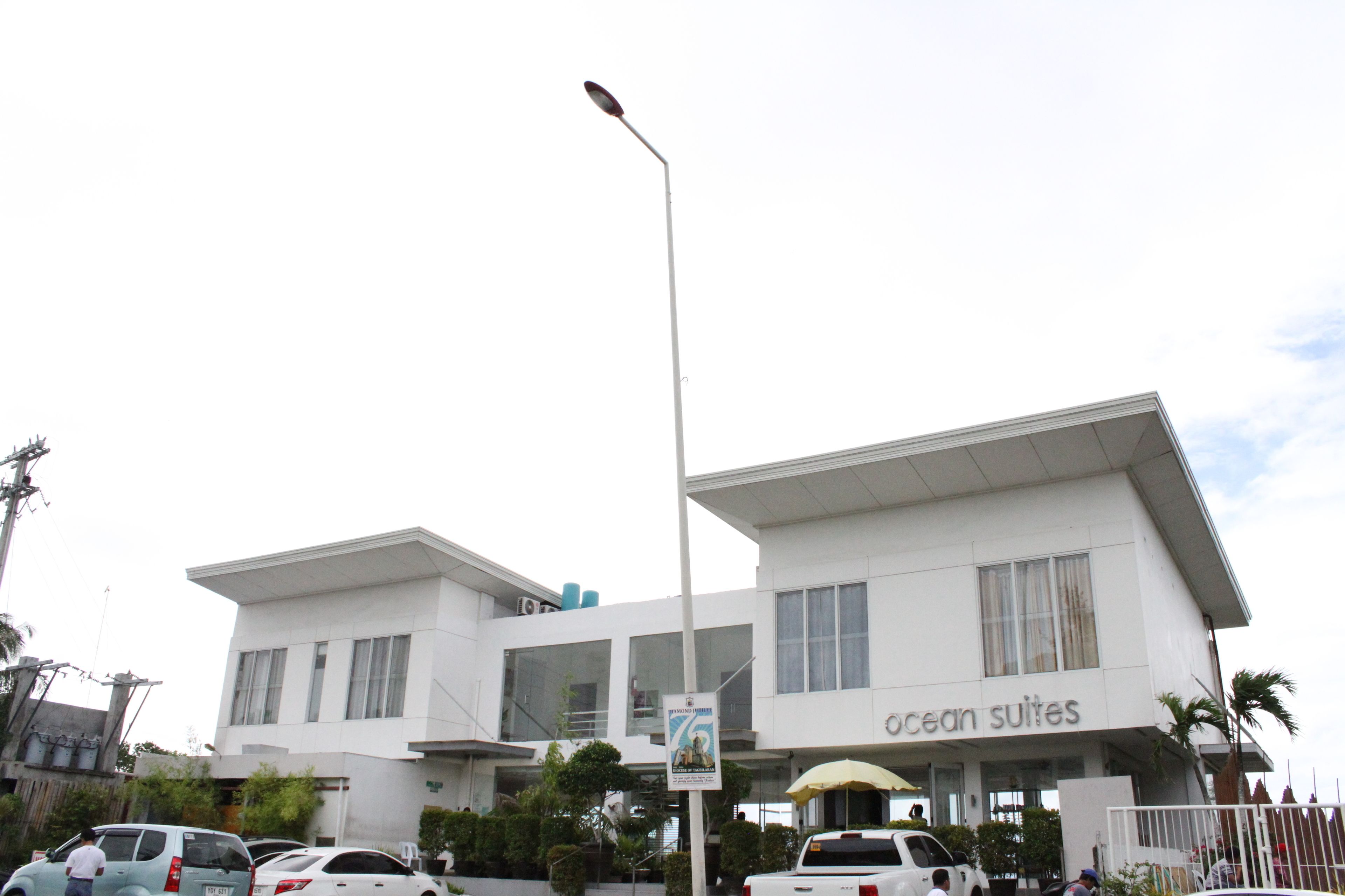 A modern building with a sign for 'Ocean Suites'.