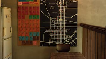 A bulletin board with various notices and a map of Sapporo.