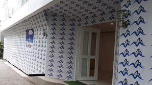A building facade with a repetitive pattern of stylized bird silhouettes. - Boracay Midtown Hotel (Boracay Island)