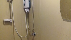 A bathroom with a shower, a toilet, and a sink. - Boracay Midtown Hotel (Boracay Island)
