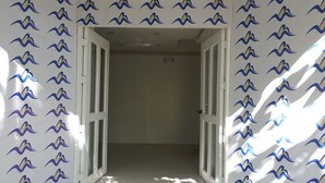 A hallway with patterned wallpaper and a door leading to another room. - Boracay Midtown Hotel (Boracay Island)