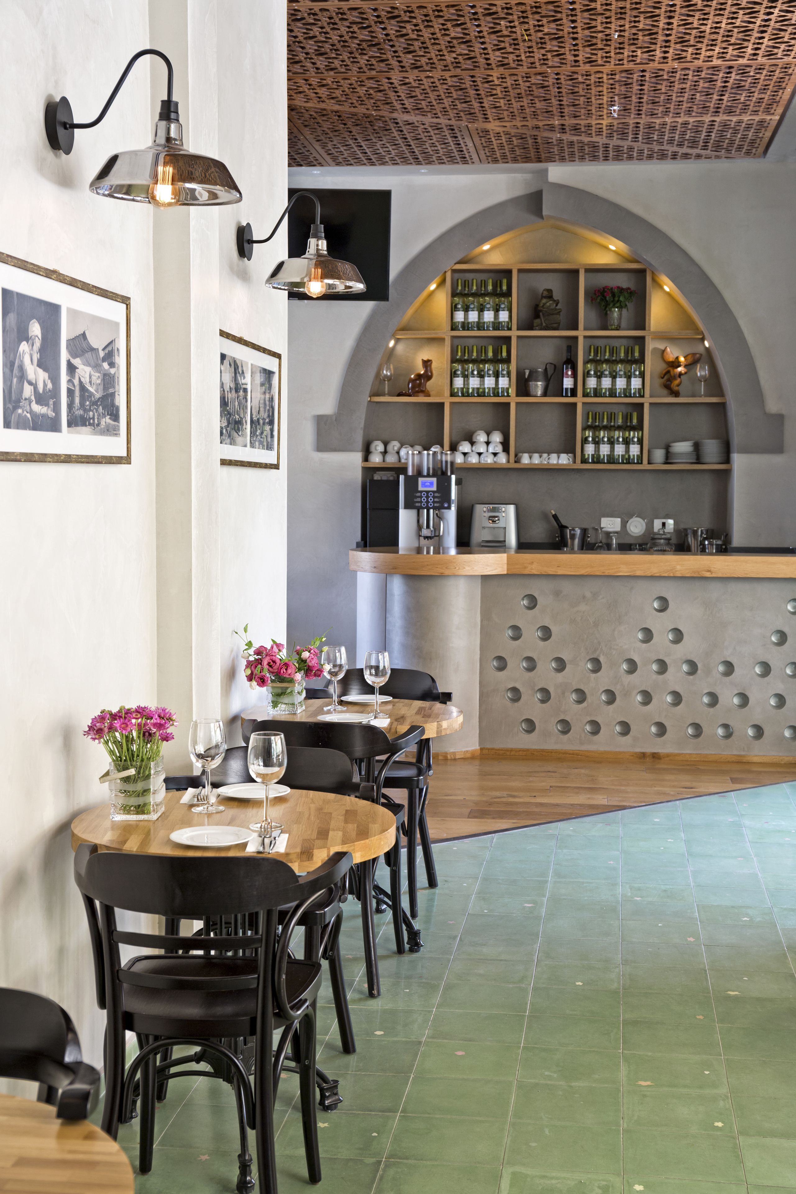 Um restaurante com área de bar, mesas e cadeiras de madeira.